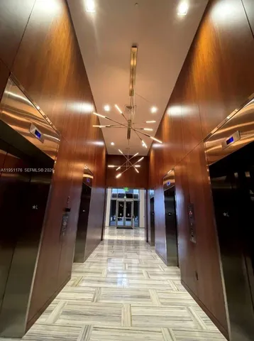 a lobby with furniture and a ceiling fan