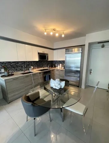 a kitchen with a table and chairs in it