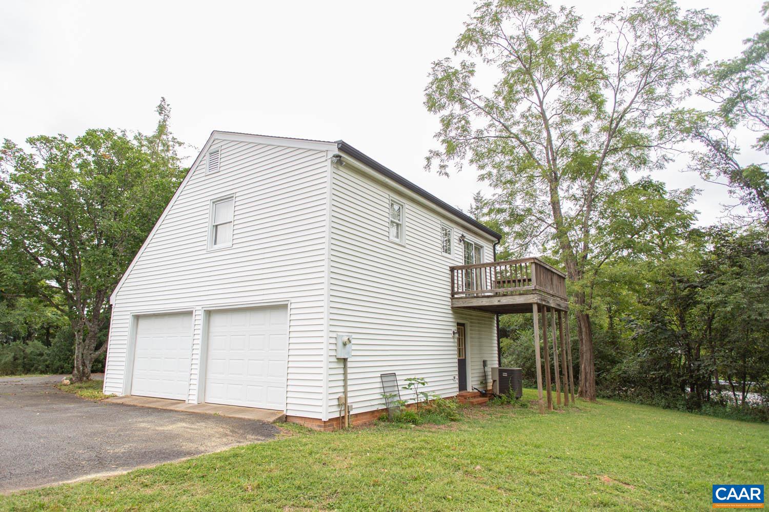 3575 Morgantown Road Charlottesville, VA 22903 - Photo 35 of 46 a view of a white house next to a yard with large trees