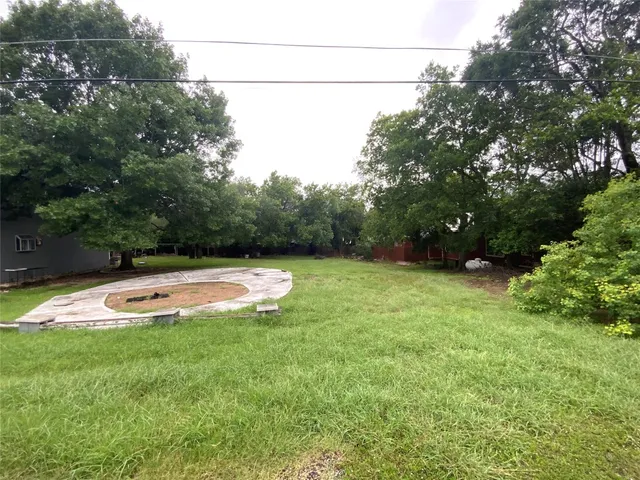 a view of a swimming pool with a yard
