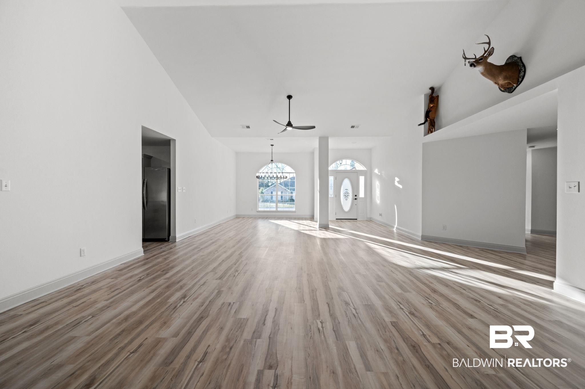 136 Destrehan Road Fairhope, AL 36532 - Photo 8 of 44 Unfurnished living room featuring a high ceiling, ceiling fan, and wood-type flooring