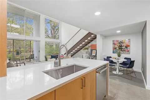 a kitchen with a table chairs and a large window