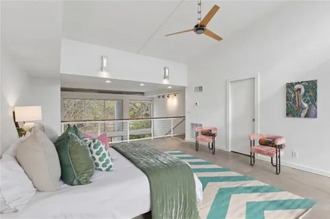 a bed room with a bed and a chair