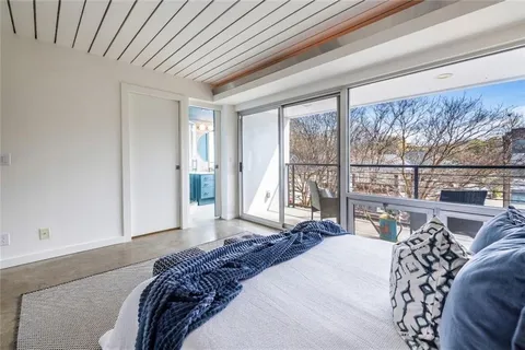 a bedroom with a large bed and a large window