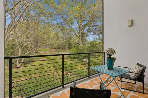 a view of a balcony with chairs
