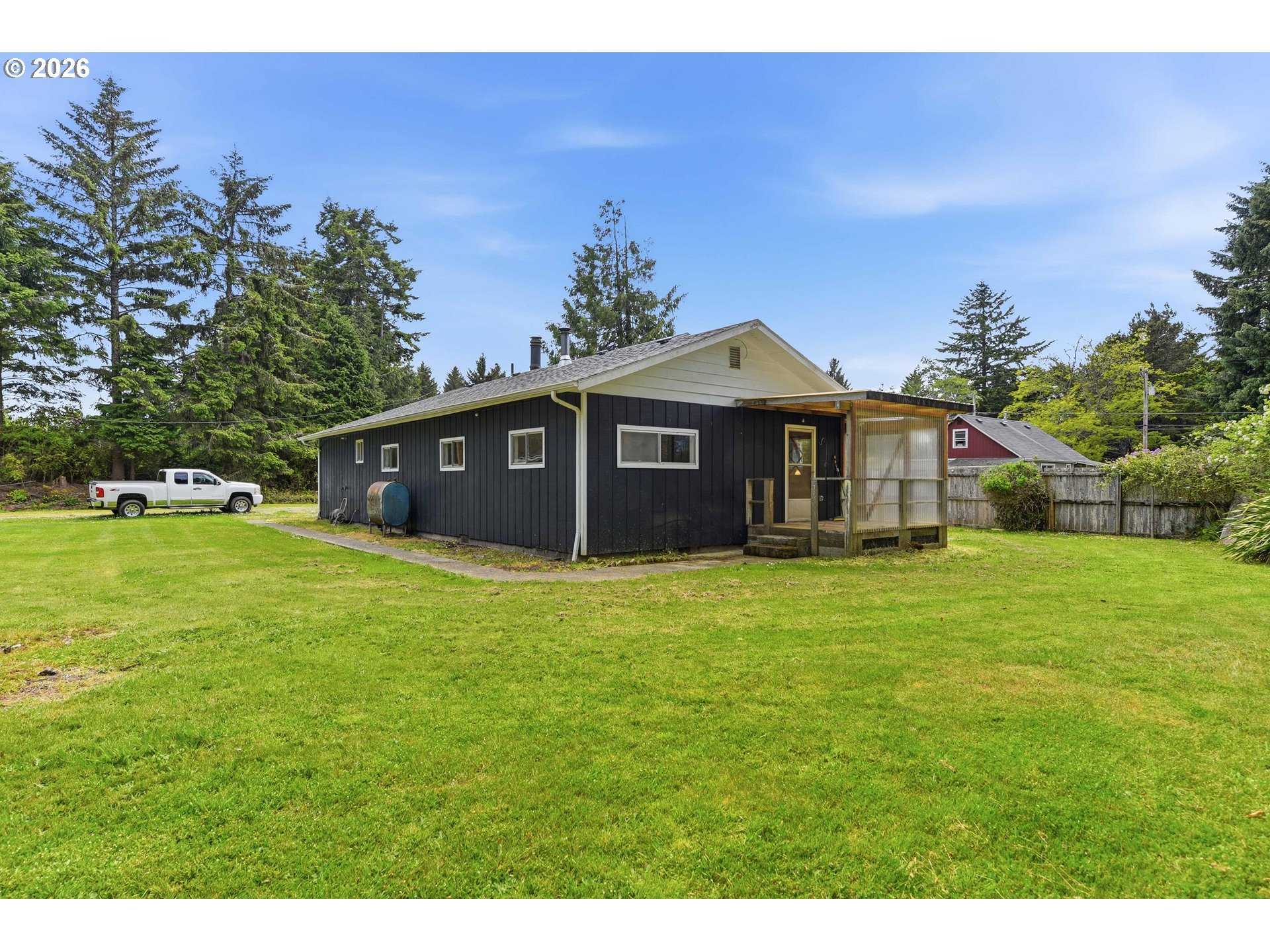 63299 Wildahl Road Coos Bay, OR 97420 - Photo 37 of 45 a front view of a house with a garden