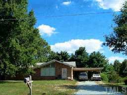 2081 Old Durham Road Roxboro, NC 27573 - Photo 1 of 1 a house that has a tree in it with wooden fence