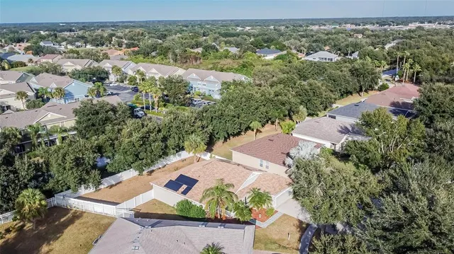 an aerial view of a house with garden space and street view