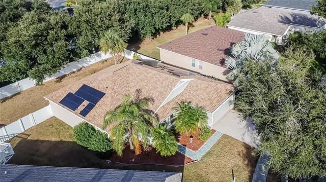 an aerial view of a house with garden space and street view