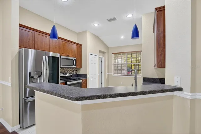 a kitchen with a refrigerator and a sink
