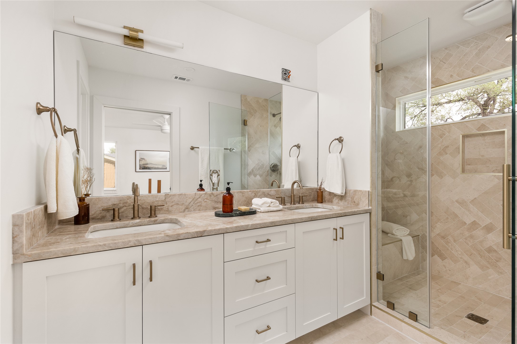 4501 Pack Saddle Pass Austin, TX 78745 - Photo 25 of 37 Dual vanity with undermount sinks, bronze faucets, and a light-toned countertop