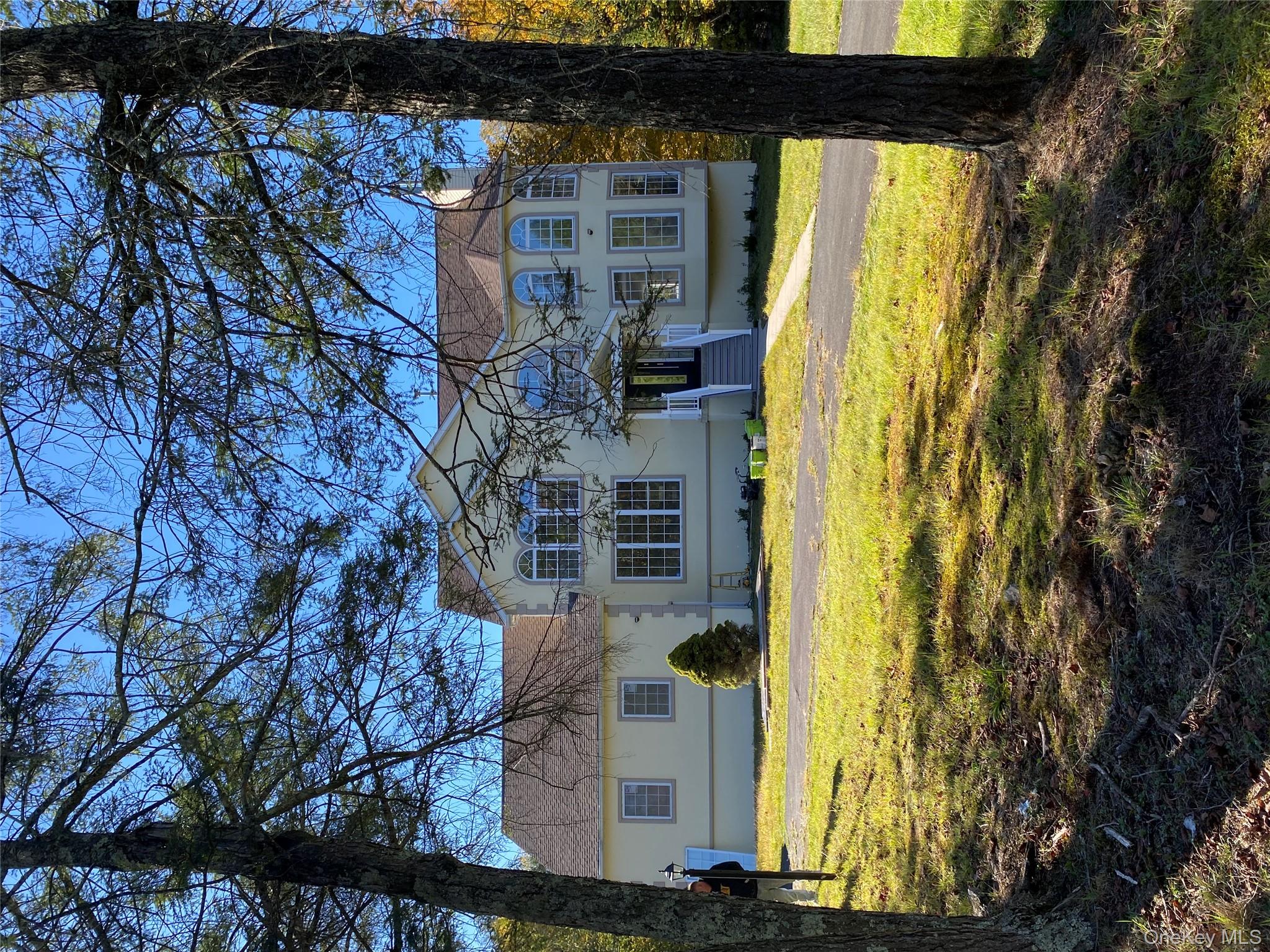 44 Roslyn Ridge Road Smallwood, NY 12778 - Photo 1 of 24 a view of a large pool with a table and chairs under an umbrella