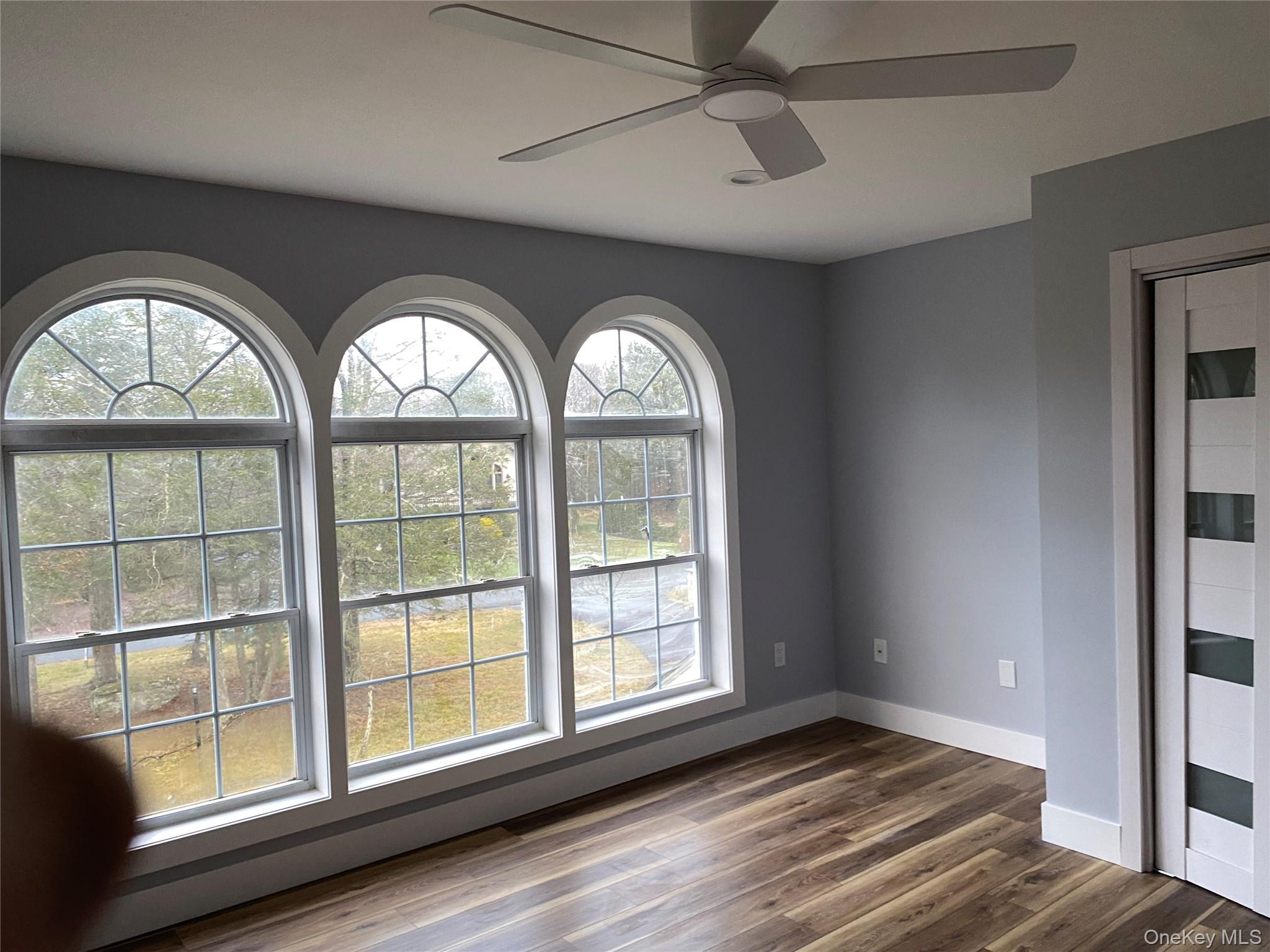 44 Roslyn Ridge Road Smallwood, NY 12778 - Photo 19 of 24 an empty room with wooden floor fan and windows