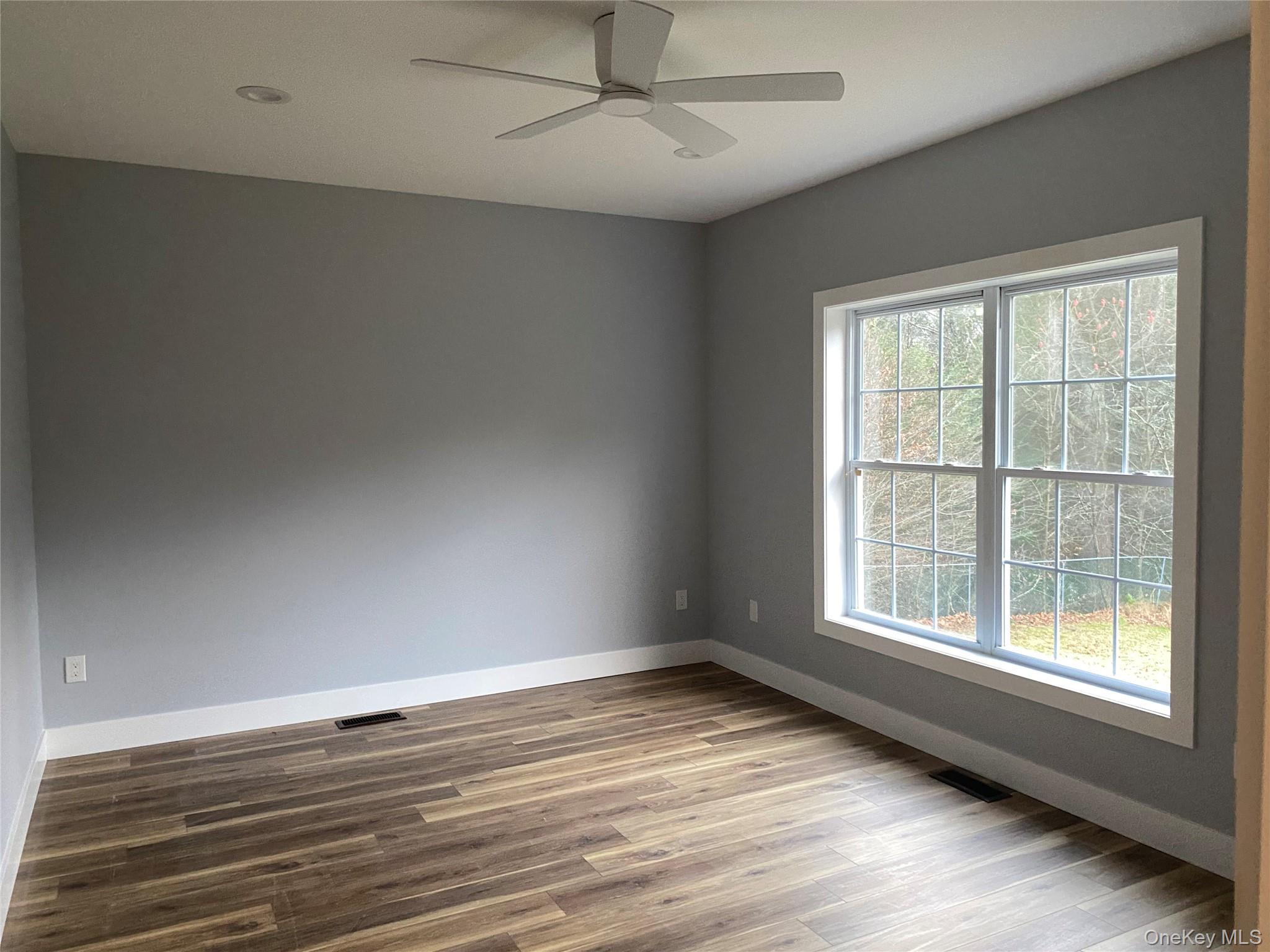 44 Roslyn Ridge Road Smallwood, NY 12778 - Photo 20 of 24 an empty room with wooden floor and windows