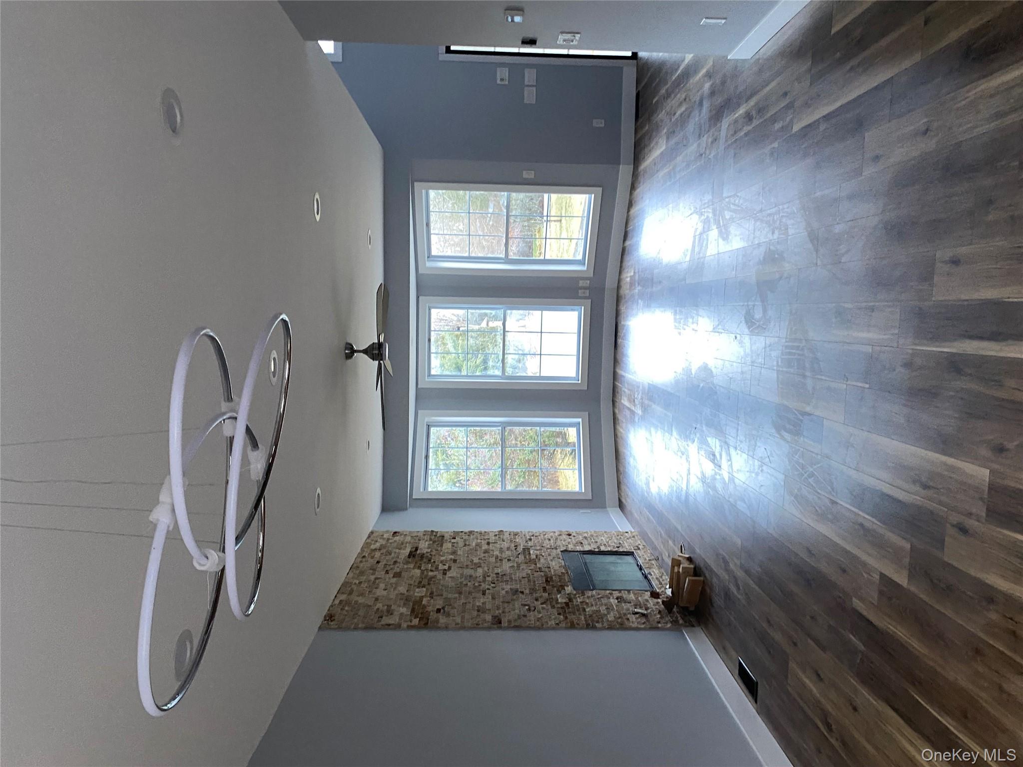 44 Roslyn Ridge Road Smallwood, NY 12778 - Photo 5 of 24 a view of an empty room with a window and wooden floor