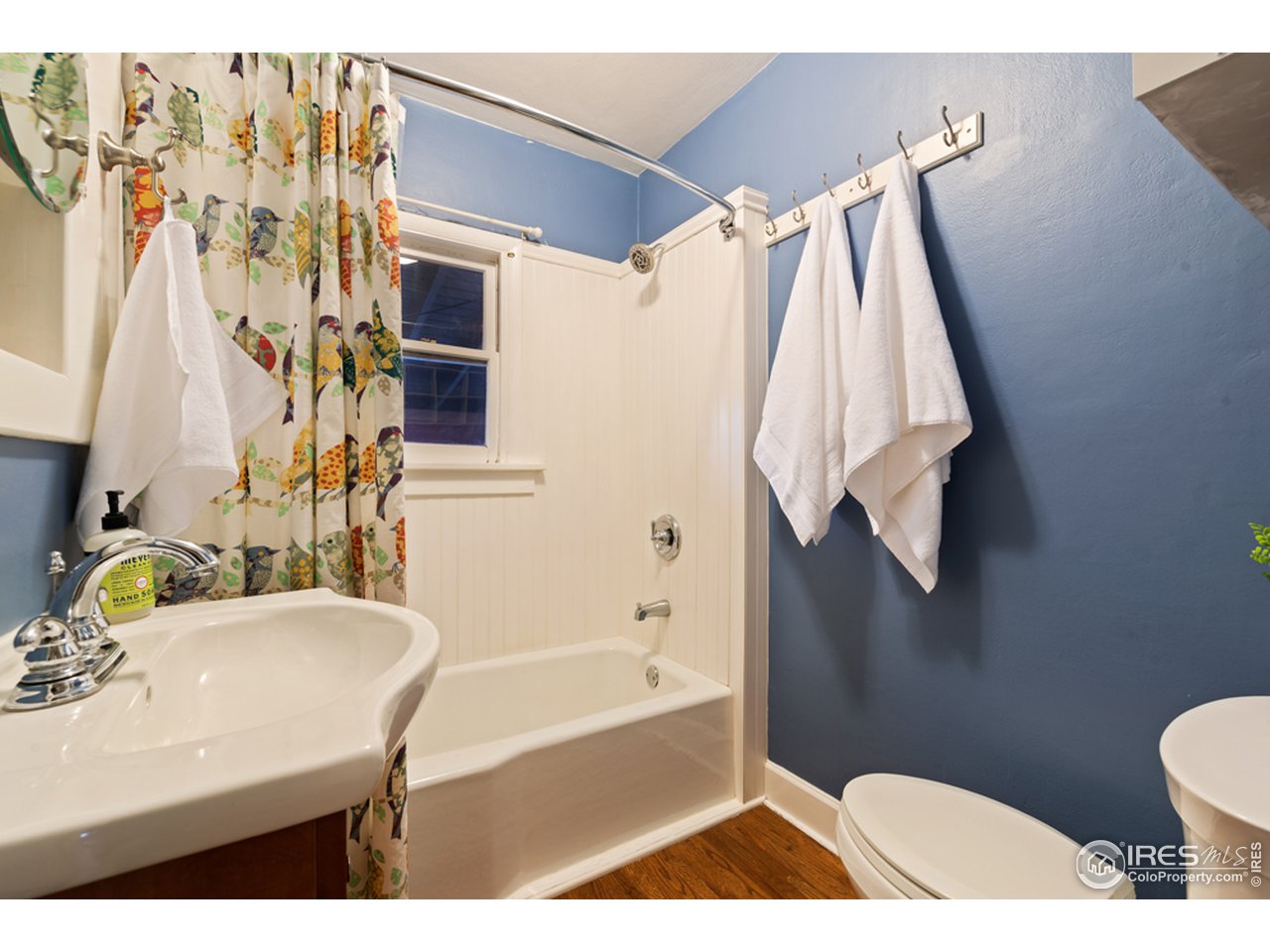 314 South Shields Street Fort Collins, CO 80521 - Photo 17 of 35 a bathroom with a sink a toilet and shower curtain