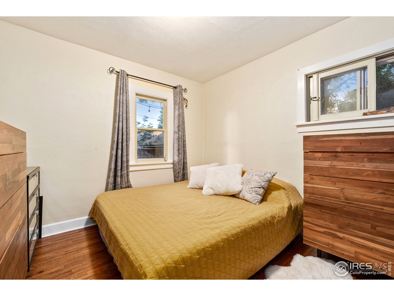 314 South Shields Street Fort Collins, CO 80521 - Photo 25 of 35 a bedroom with a bed and a window