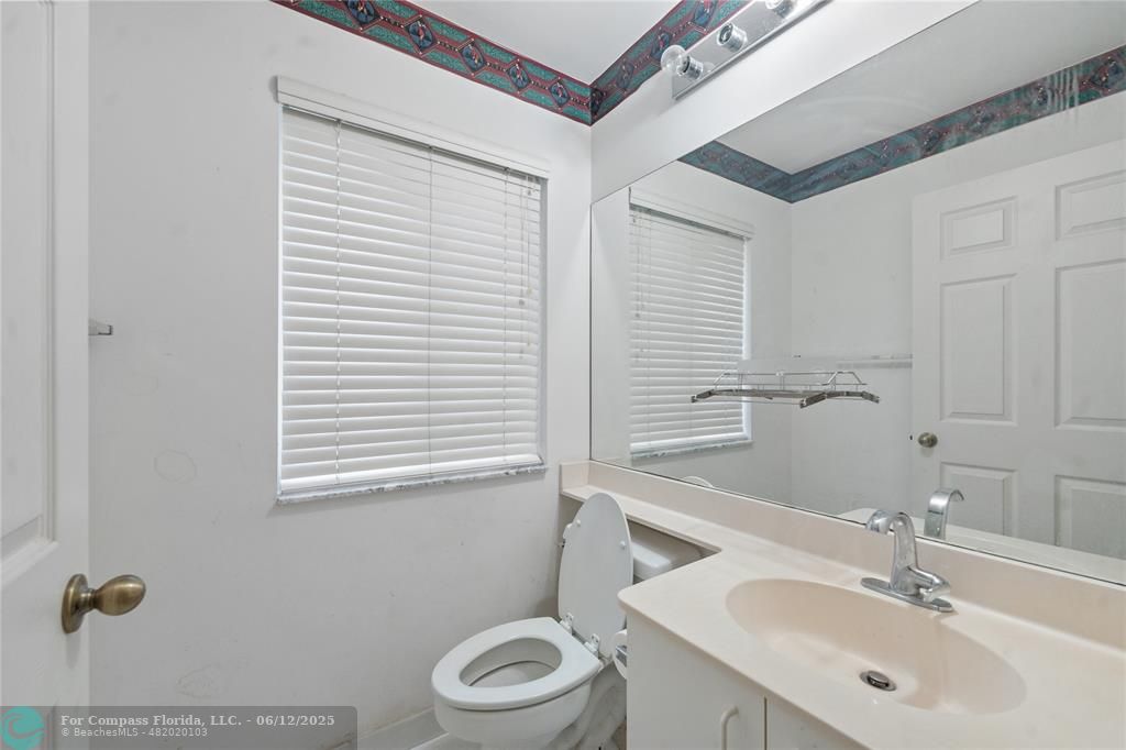 10772 Southwest 14th Place Davie, FL 33324 - Photo 13 of 19 a bathroom with a sink a toilet and mirror