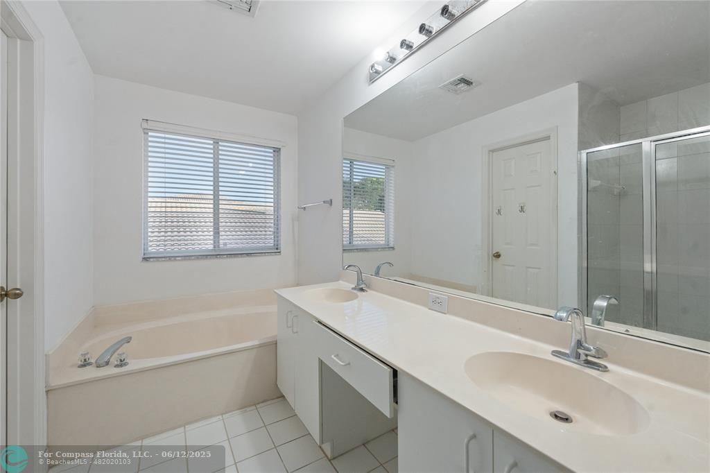 10772 Southwest 14th Place Davie, FL 33324 - Photo 15 of 19 a bathroom with a tub a sink double vanity and a mirror