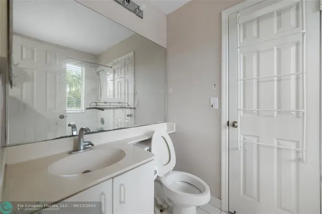 a bathroom with a sink toilet and vanity
