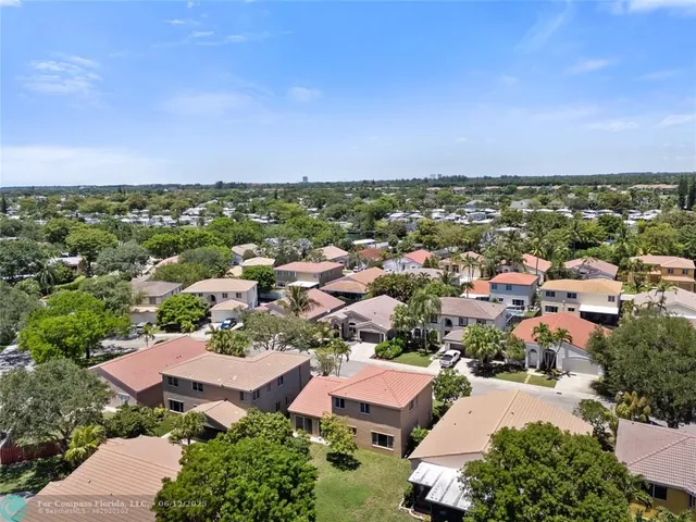 an aerial view of residential houses with city view