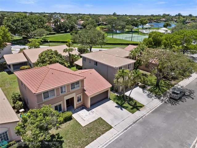 an aerial view of a house with a garden and lake view