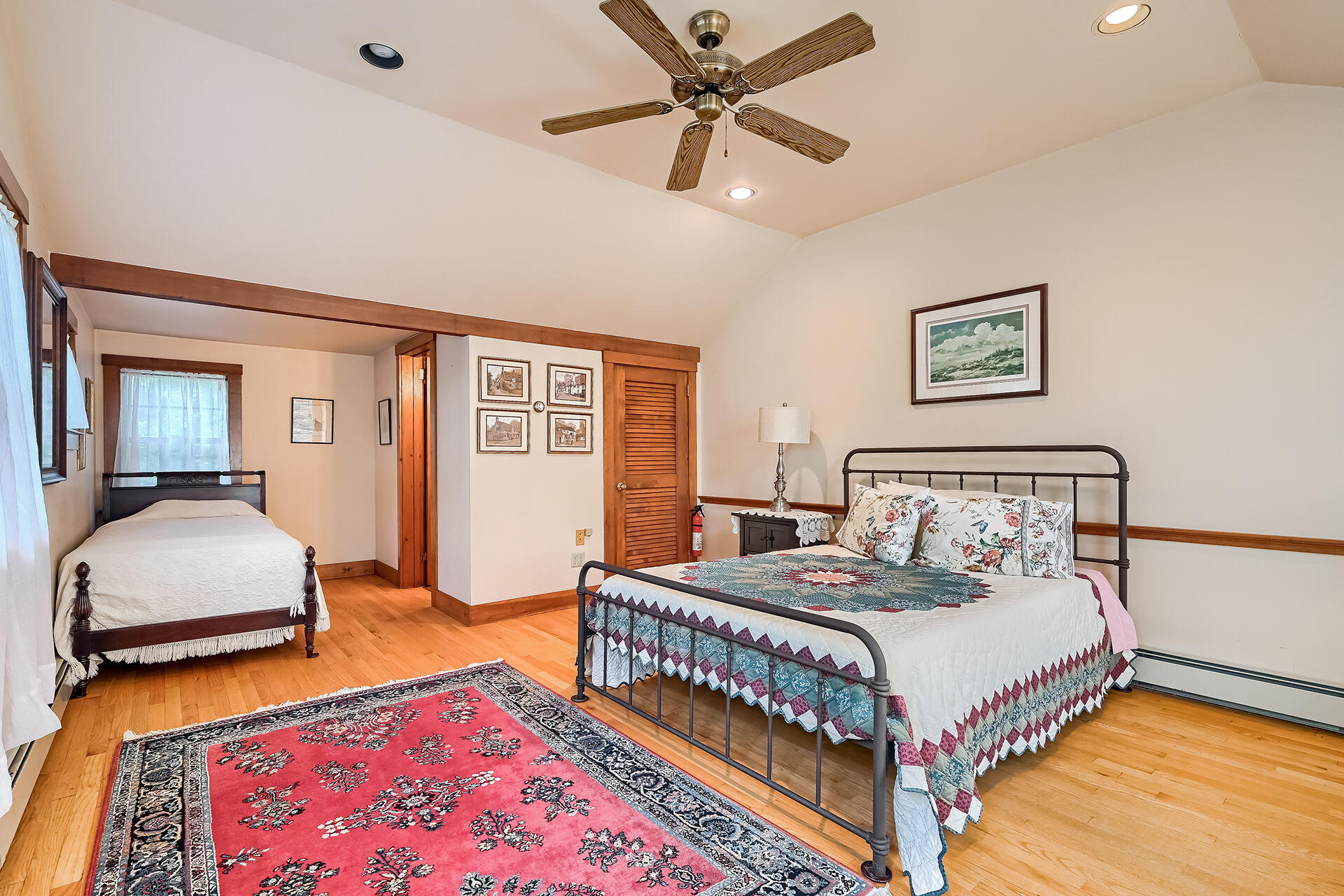 497 Main Street Centerville, MA 02632 - Photo 31 of 50 a bedroom with a bed a window and a chandelier