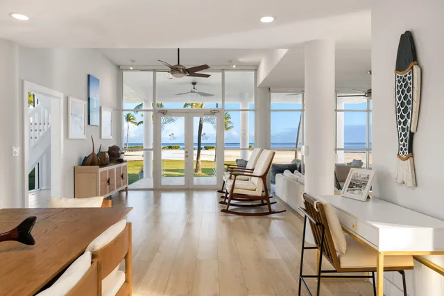 a bedroom with a bed a couch and large window