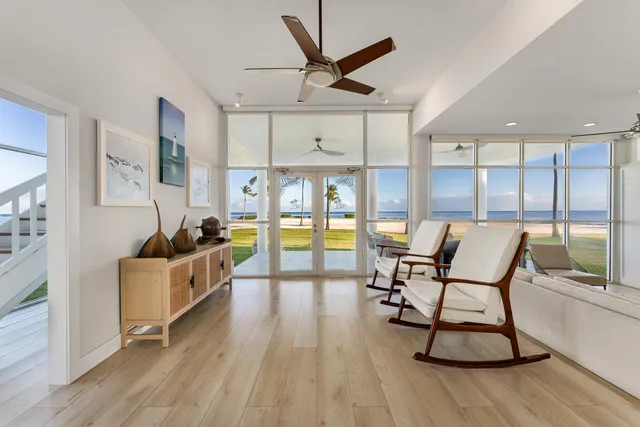 a large bed sitting in a bedroom and a chandelier