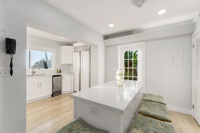 a bathroom with a sink vanity granite and a mirror