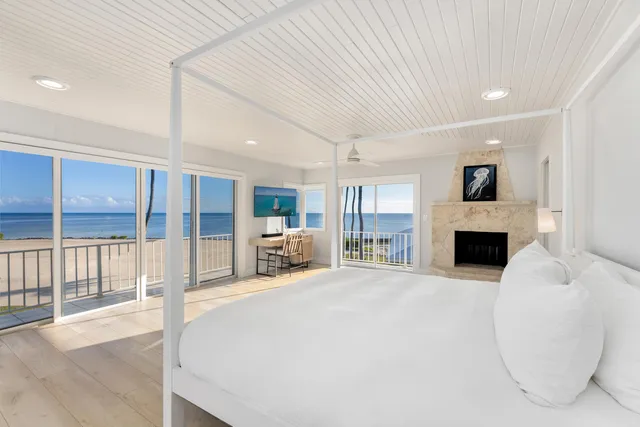 a view of lawn chairs and table under an umbrella