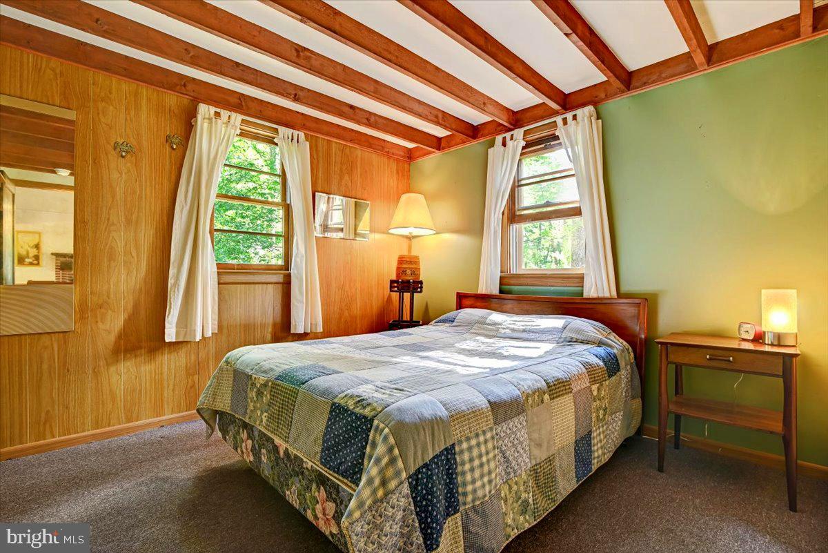 112 Beechwood Cove Road Greentown, PA 18426 - Photo 16 of 59 a bed sitting in a bedroom next to a window