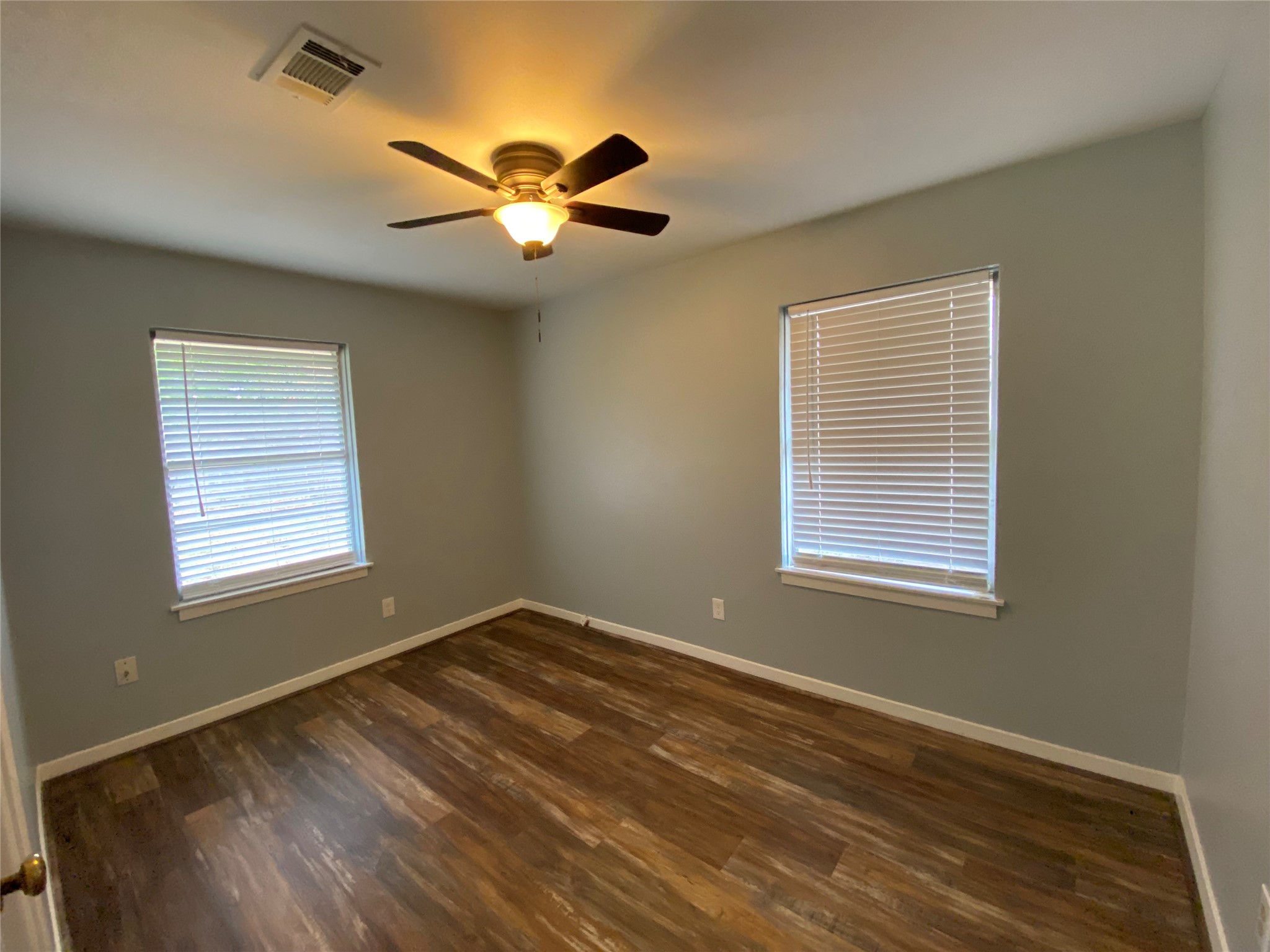 5110 West 43rd Street Houston, TX 77092 - Photo 12 of 26 a view of an empty room with wooden floor and a window