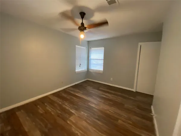 a view of an empty room and wooden floor