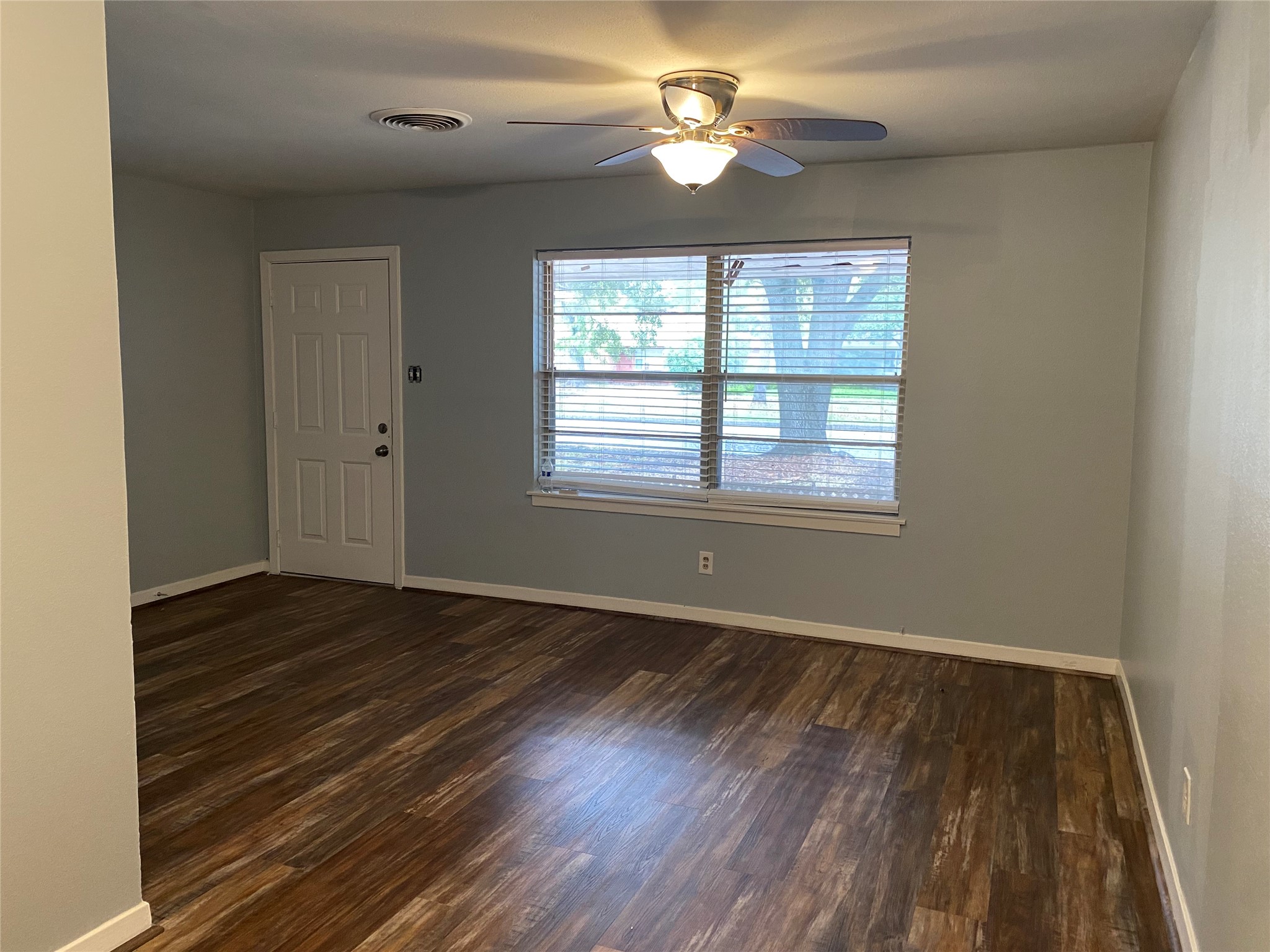 5110 West 43rd Street Houston, TX 77092 - Photo 2 of 26 wooden floor in an empty room with a window