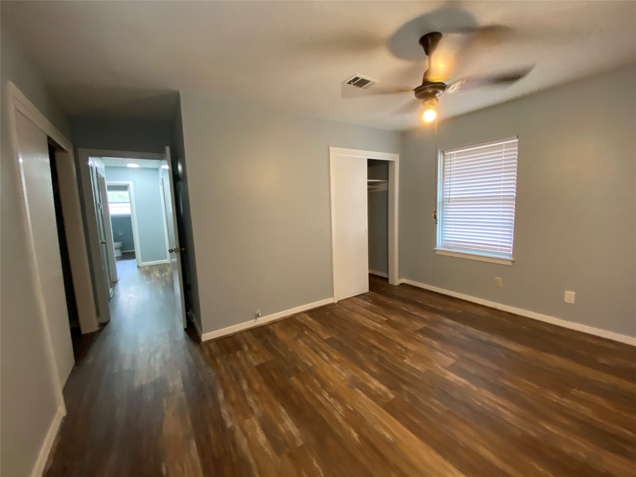 5110 West 43rd Street Houston, TX 77092 - Photo 21 of 26 an empty room with wooden floor and windows