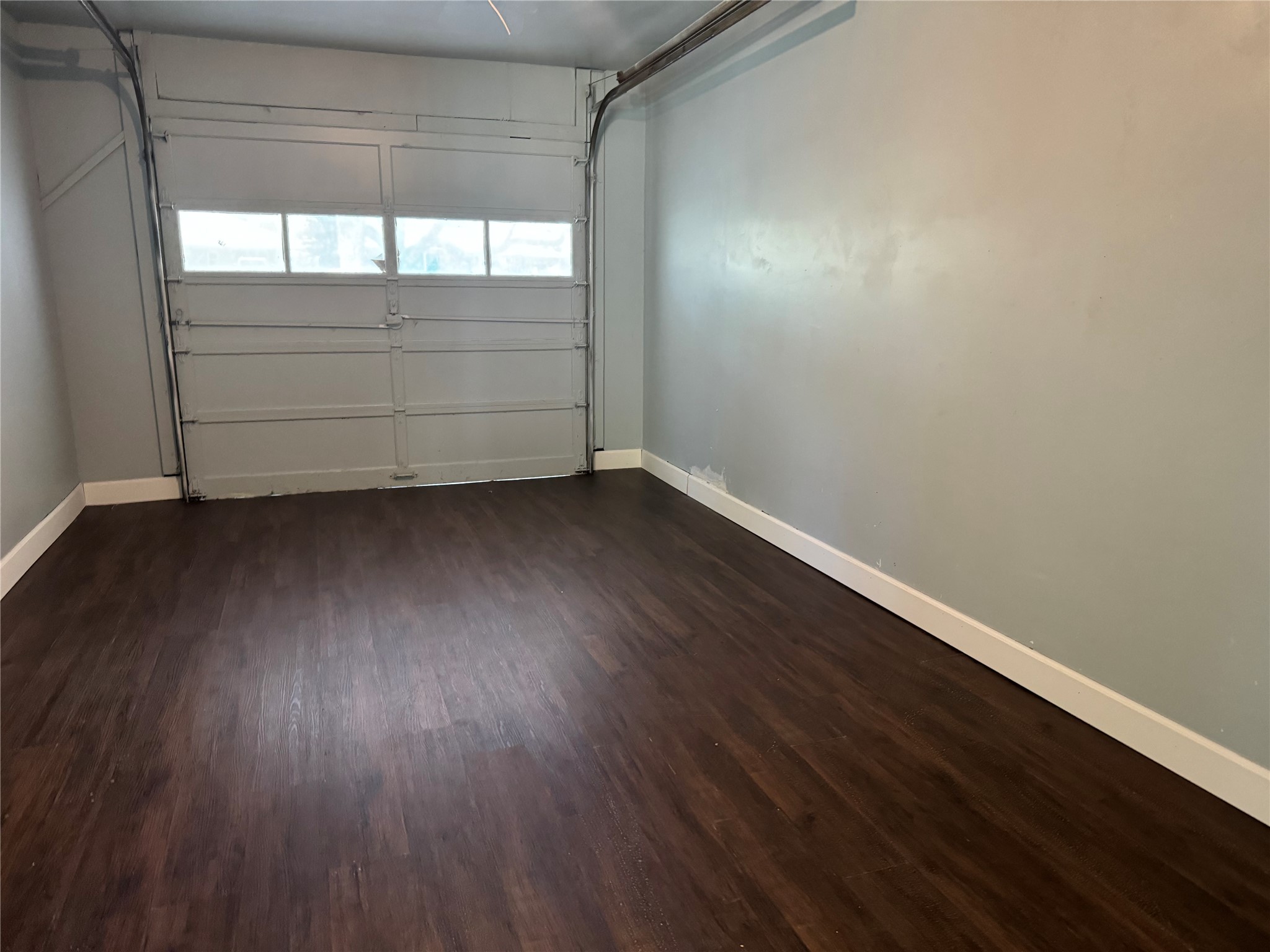 5110 West 43rd Street Houston, TX 77092 - Photo 25 of 26 an empty room with wooden floor and windows