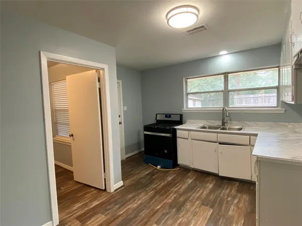 a kitchen with a refrigerator and a sink