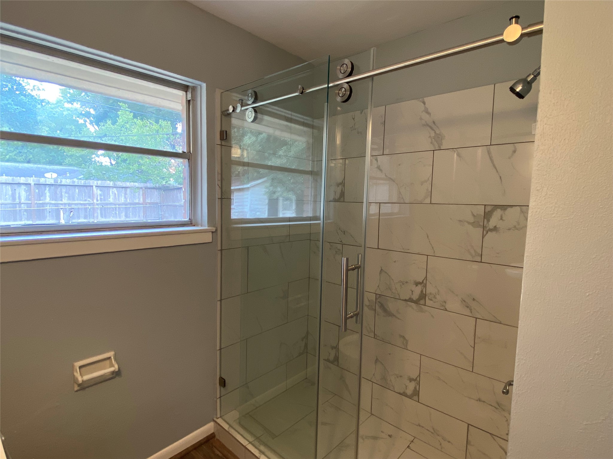 5110 West 43rd Street Houston, TX 77092 - Photo 9 of 26 a bathroom with a shower and a window