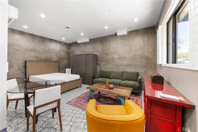 a living room with furniture and a toilet