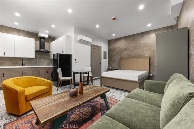 a living room with furniture and a pool table