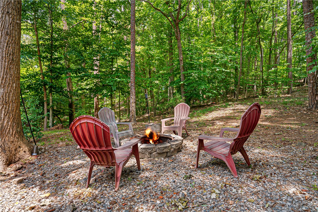 139 Tulip Lane Westminster, SC 29693 - Photo 16 of 37 A secluded fire pit area offers a peaceful retreat amidst natural wooded surroundings.