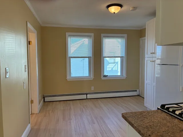 a view of a livingroom with wooden floor and a window