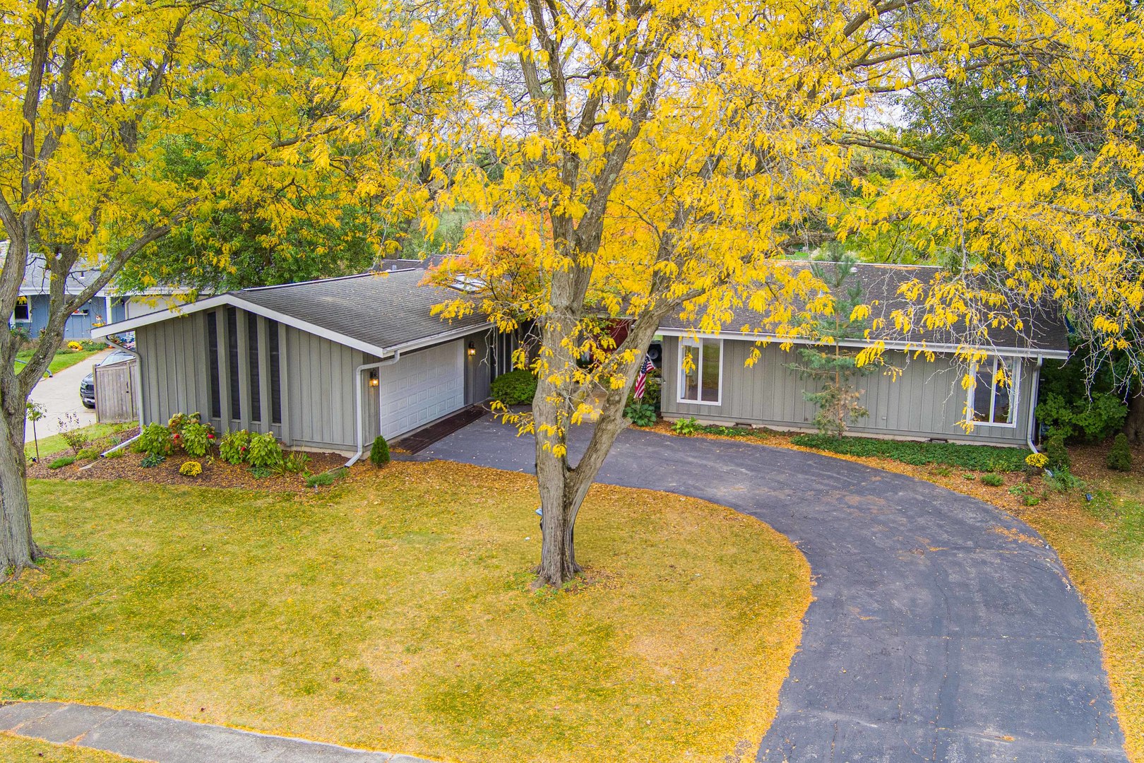 a yellow house with trees in front of it