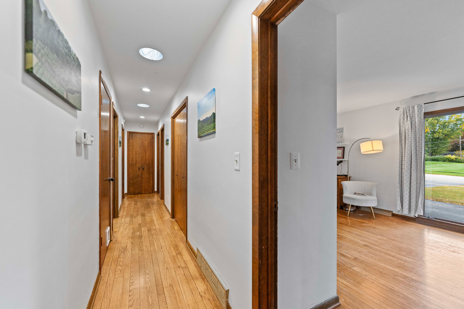 120 Stoney Creek Road DeKalb, IL 60115 - Photo 18 of 32 a view of a hallway with wooden floor and a living room