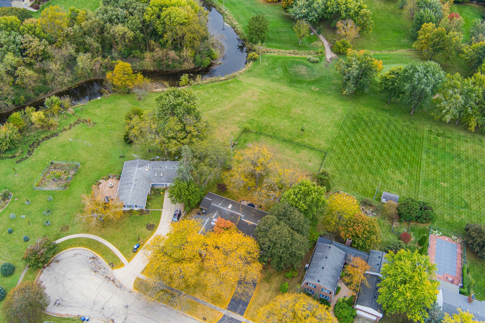 120 Stoney Creek Road DeKalb, IL 60115 - Photo 25 of 32 an aerial view of residential house with pool and trees