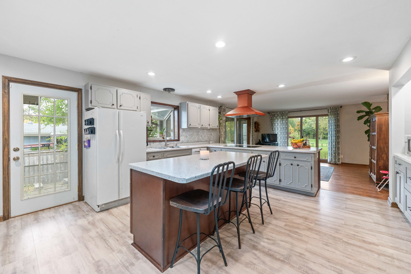 120 Stoney Creek Road DeKalb, IL 60115 - Photo 4 of 32 a kitchen with stainless steel appliances granite countertop a kitchen island hardwood floor sink stove dining table and chairs