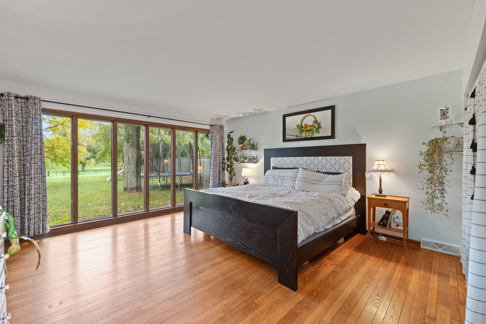 120 Stoney Creek Road DeKalb, IL 60115 - Photo 9 of 32 a spacious bedroom with a bed and a wooden floor