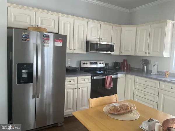 a view of a dining room with furniture wooden floor and a chandelier