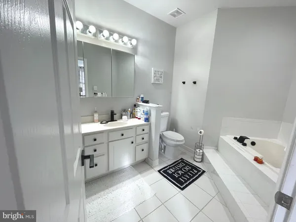 a view of a backyard with plants and a bench